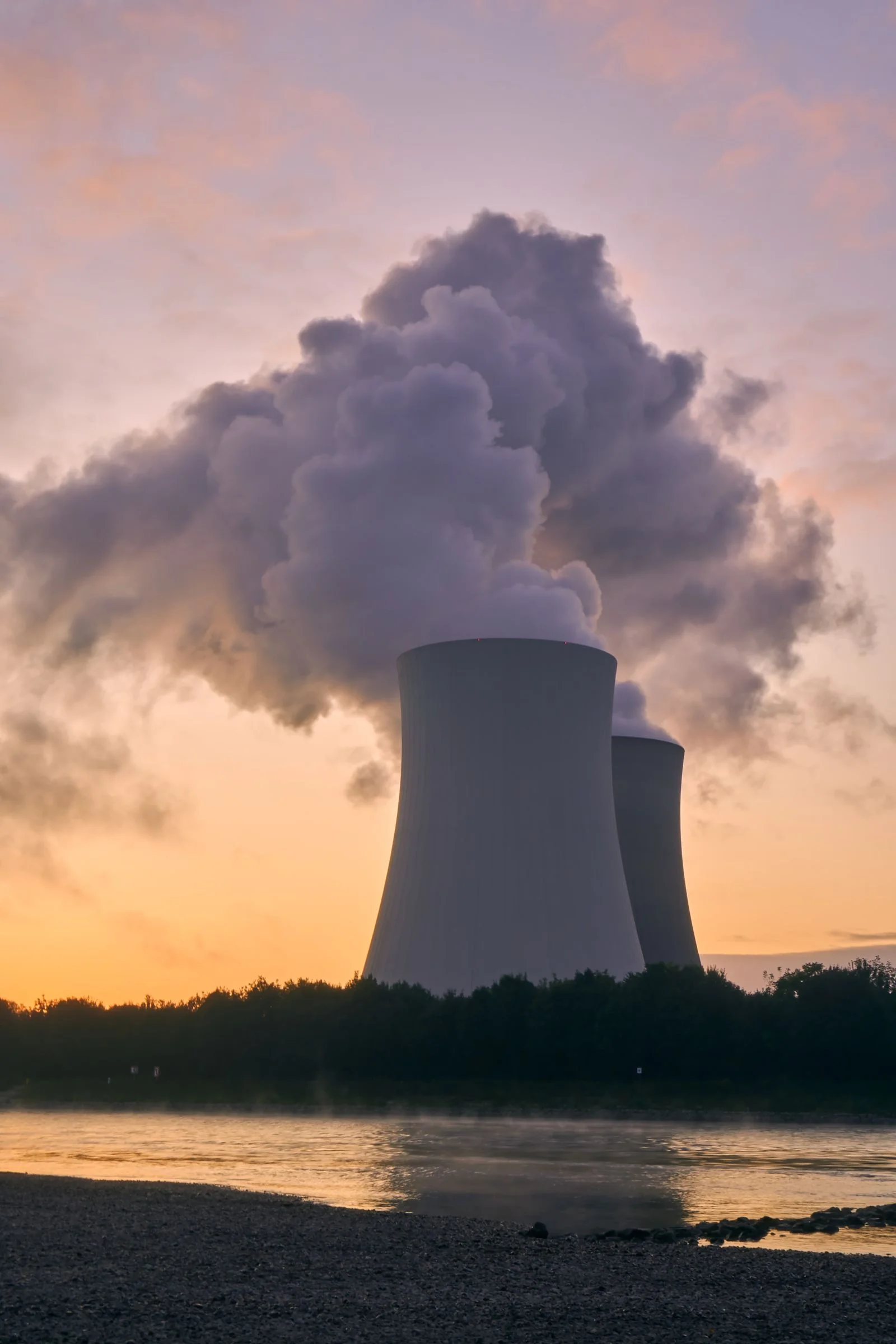 Nuclear power plant cooling towers at sunset